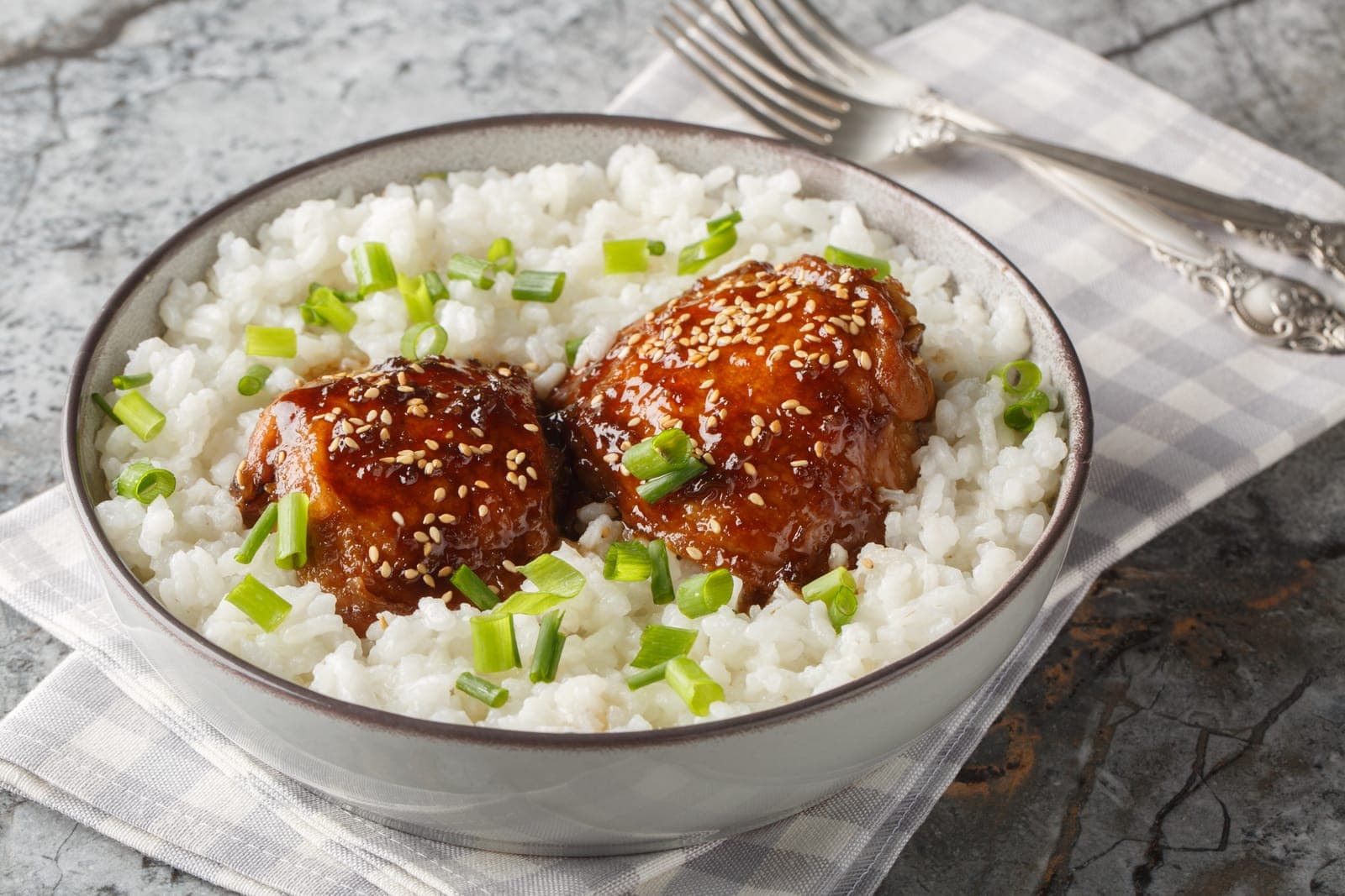 Shoyu chicken — bone-in thighs braised in a glossy sweet-salty soy, ginger, and garlic glaze, scattered with scallions over rice
